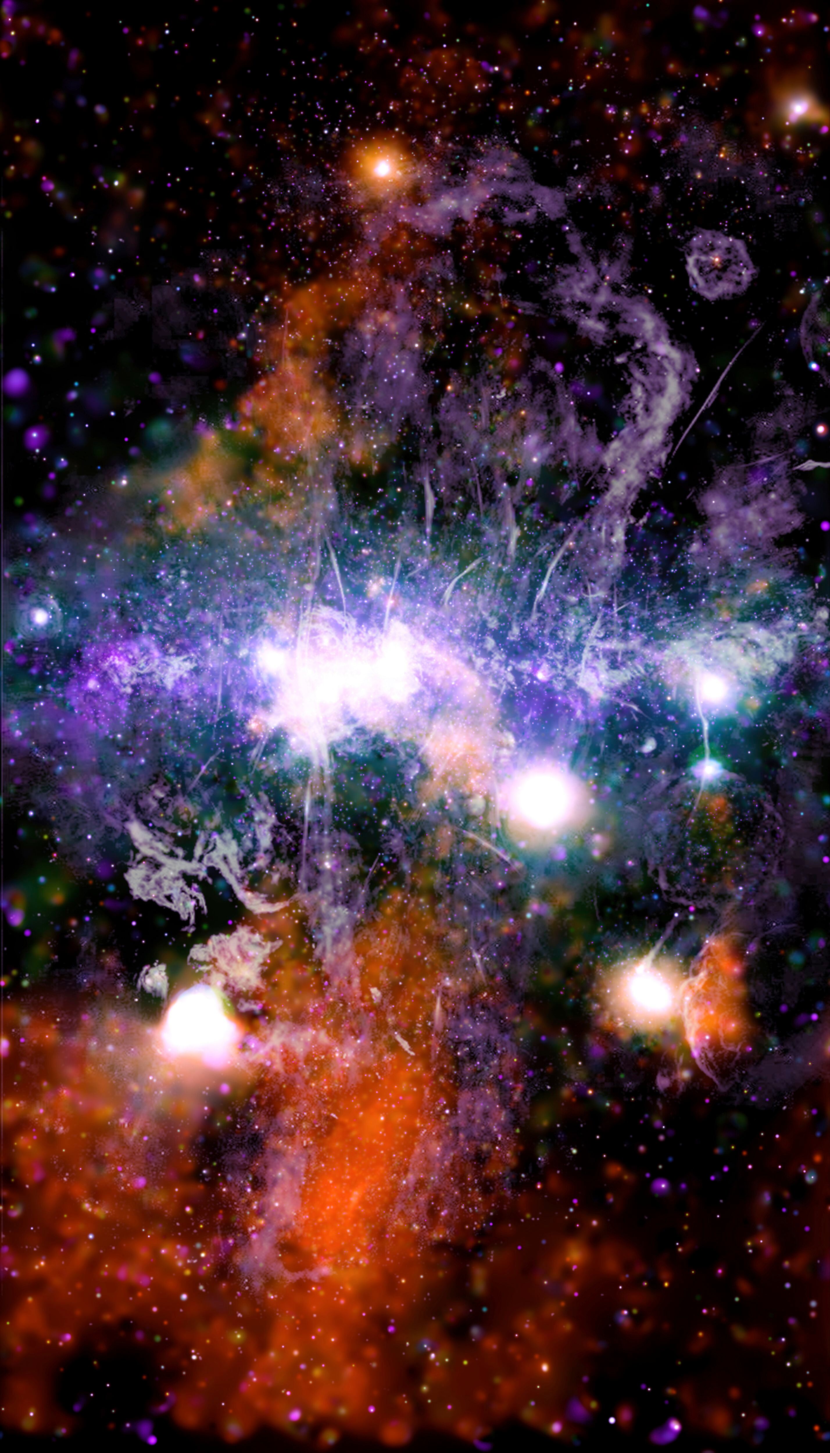 Esta imagen facilitada por la NASA y a la que se le pusieron colores muestra puntos de rayos X y radiofrecuencia iluminados así como chorros de gas supercaliente y campos magnéticos en el centro de la vía Láctea.