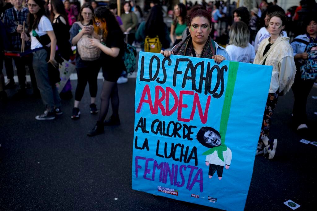 Sara Rivas lleva un cartel que muestra al aspirante presidencial Javier Milei y un mensaje de protesta, antes del inicio de la marcha por el Día Internacional del Aborto Seguro en Buenos Aires, Argentina.
