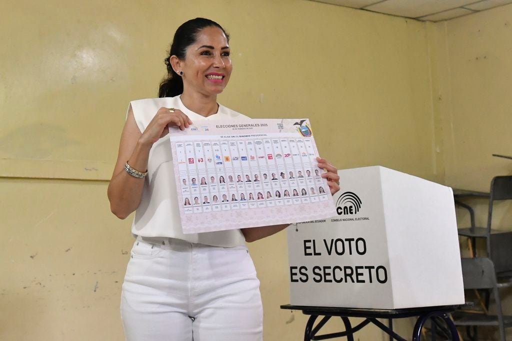 Luisa González, candidata del Movimiento Revolución Ciudadana, levanta su papeleta antes de votar en los comicios presidenciales en Canuto, Ecuador. (Foto AP/Jairo Mendoza)